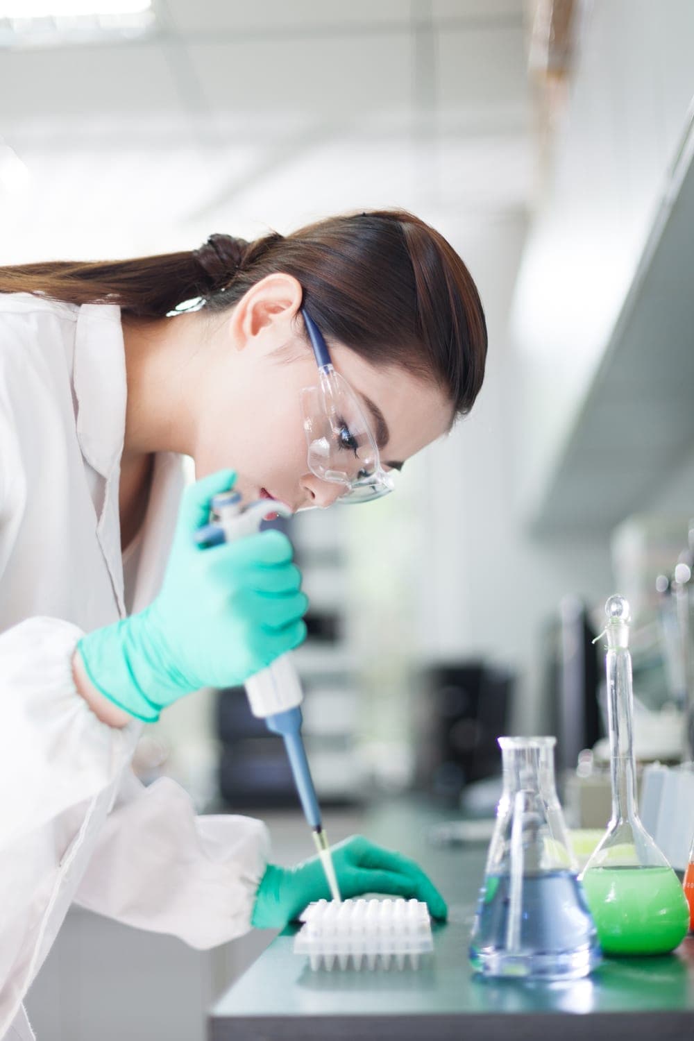 A scientist pipetting samples at a laboratory bench