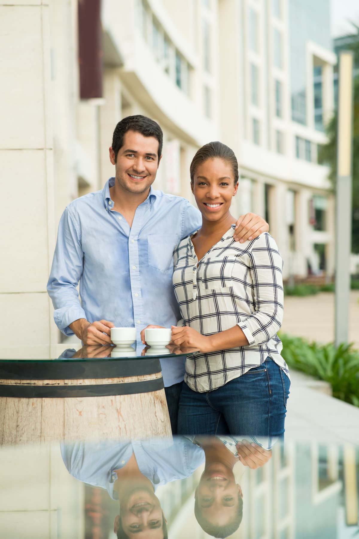 A smiling couple outside a U.S. apartment building