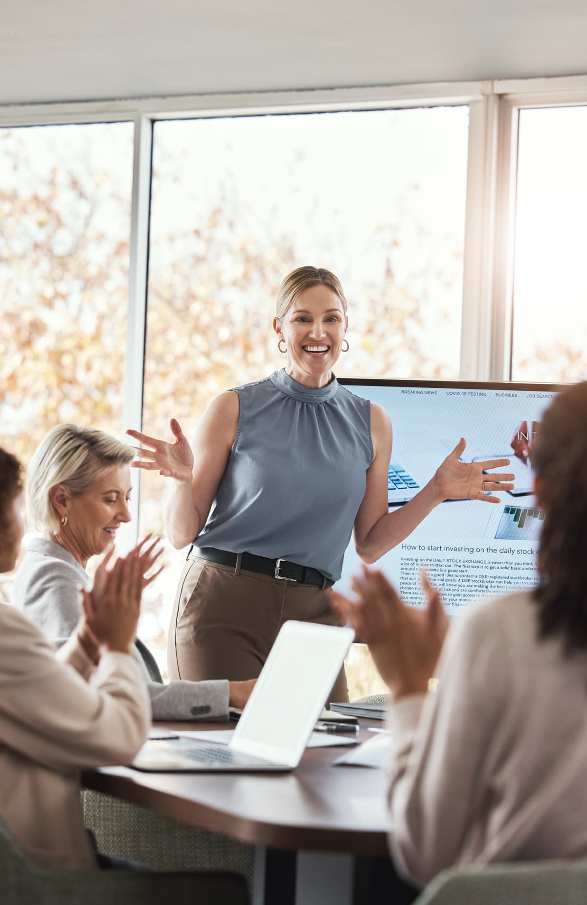 A businesswoman presenting to colleagues in a meeting