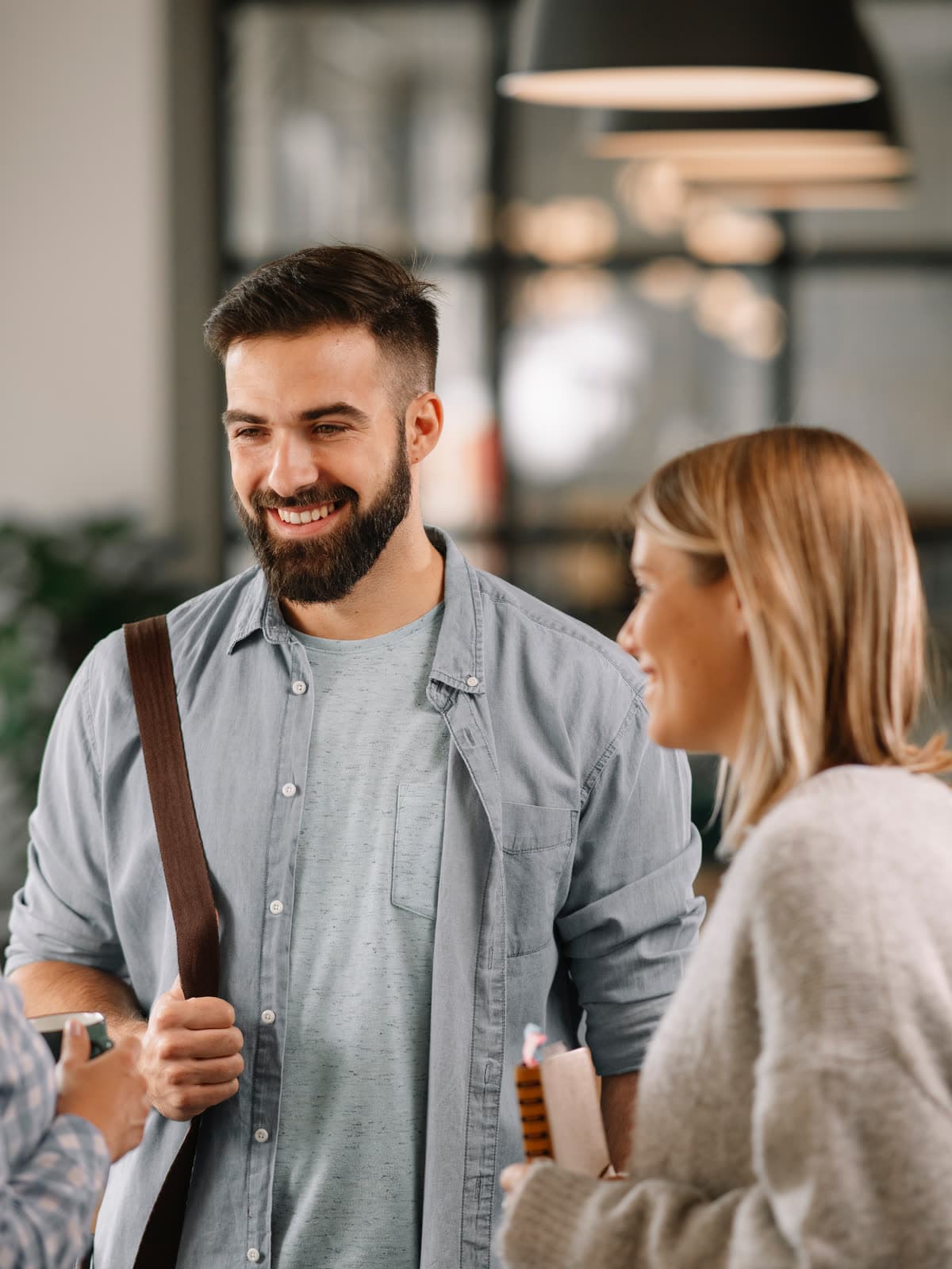 A professional in conversation with colleagues in a modern office
